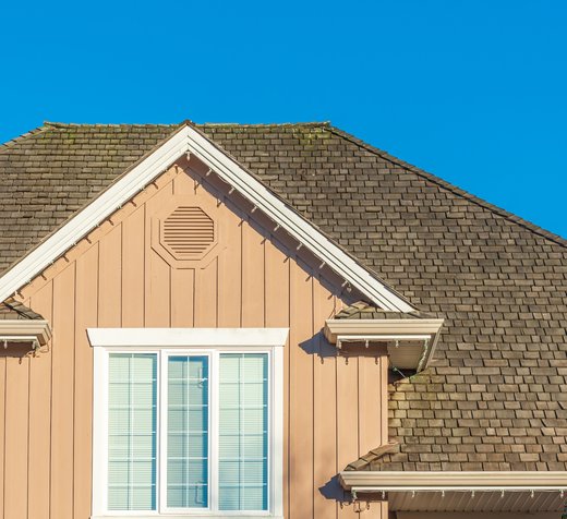 Steep gable roof with architectural shingles after replacement