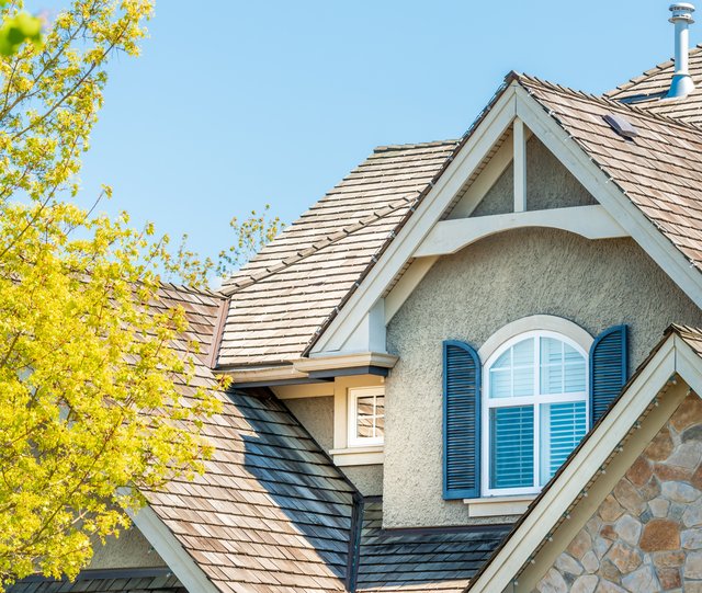 Roofer inspecting a tile roof near the Denver Tech Center